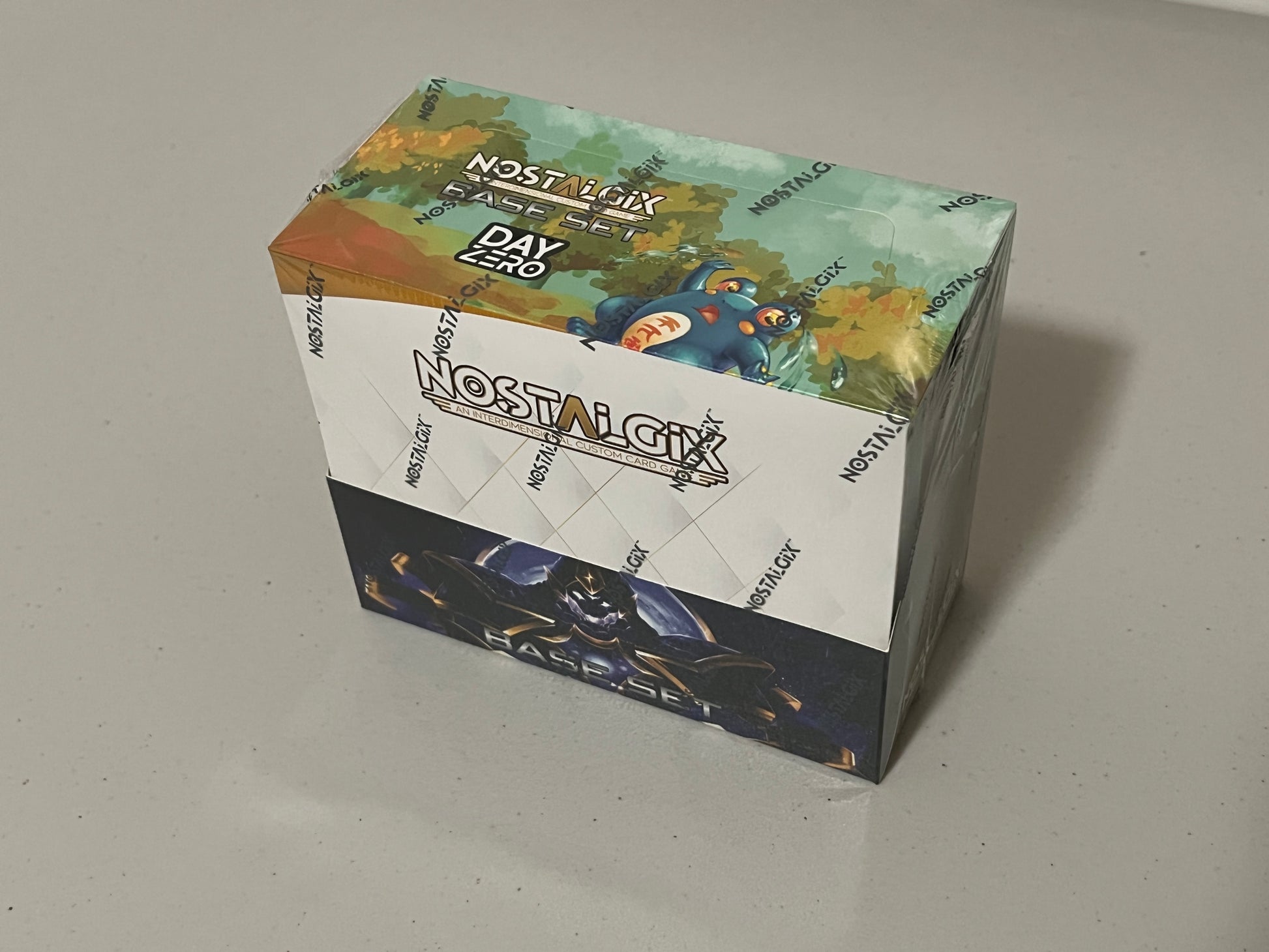 Nostalgix TCG - Day Zero (Kickstarter) - Booster Box uptownhobbies Nostalgix TCG - Day Zero (Kickstarter) - Booster Box uptownhobbies